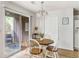 Charming dining area with a round table, modern chandelier, and sliding door to the screened porch at 7935 Parklane Ct # A, North Charleston, SC 29418