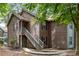 Two-story condo featuring wood siding and a stairway leading to the upper level entrance at 7935 Parklane Ct # A, North Charleston, SC 29418