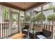 Cozy screened porch with comfortable seating and a view of the surrounding greenery at 7935 Parklane Ct # A, North Charleston, SC 29418
