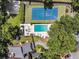 Aerial shot highlighting tennis court and pool, nestled amid verdant landscaping, and nearby homes at 8 Pony Ln, Charleston, SC 29407