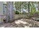 Exterior view of a back deck shaded by trees, adjoined by wood railings and an enormous tree at 8 Pony Ln, Charleston, SC 29407
