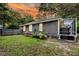 Landscaped backyard with a well-maintained lawn, wooden fence, and enclosed patio at 8 Pony Ln, Charleston, SC 29407