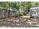 Lush backyard featuring a fenced yard, verdant trees, and a charming sunroom at 8 Pony Ln, Charleston, SC 29407