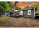Backyard featuring screened-in porch, shed, mature trees, and view of the home's exterior at 8 Pony Ln, Charleston, SC 29407