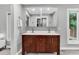 Bathroom featuring a double sink with cherry wood cabinets, tile floor, and modern fixtures at 8 Pony Ln, Charleston, SC 29407