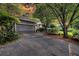 Exterior view of a home with well-manicured landscaping and a garage at 8 Pony Ln, Charleston, SC 29407