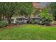 Charming single-story home featuring a well-manicured lawn and lush landscaping at 8 Pony Ln, Charleston, SC 29407