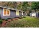 Home exterior view with a well-manicured lawn, garden beds, and shed at 8 Pony Ln, Charleston, SC 29407
