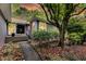 Stylish front entrance with black door, manicured landscaping, and paved walkway at 8 Pony Ln, Charleston, SC 29407