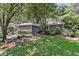 Charming home with lush landscaping in the front yard, showcasing verdant plants and flowers at 8 Pony Ln, Charleston, SC 29407
