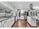 Well-lit kitchen with stainless steel appliances, granite countertops and custom white cabinets at 8 Pony Ln, Charleston, SC 29407