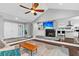 Bright living room featuring a fireplace, modern fan and seamless flow into the kitchen at 8 Pony Ln, Charleston, SC 29407