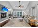 Spacious living room with a fireplace, ceiling fan, and easy access to the outdoor area at 8 Pony Ln, Charleston, SC 29407