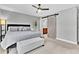 This main bedroom features a ceiling fan, barn door, and a view into the ensuite bathroom at 8 Pony Ln, Charleston, SC 29407