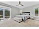 Main bedroom with light walls, carpet, ceiling fan, and access to outdoor patio at 8 Pony Ln, Charleston, SC 29407