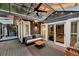 Relaxing covered patio with hot tub, ceiling fan, and comfortable seating area at 8 Pony Ln, Charleston, SC 29407