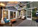 Inviting screened-in porch with comfortable seating, ceiling fan, string lights, and outdoor views at 8 Pony Ln, Charleston, SC 29407