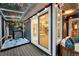 Screened porch featuring a hot tub, string lights, and comfortable seating with exterior access at 8 Pony Ln, Charleston, SC 29407