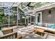 Inviting sunroom with an outdoor patio set, ceiling fan, and ample light filtering through the screens at 8 Pony Ln, Charleston, SC 29407
