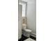 Neat bathroom with white toilet, modern black and white art, and minimalist decor at 84 Bull St # F, Charleston, SC 29401