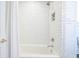 Clean bathroom with a tub/shower combo, subway tile, and white finishes at 84 Bull St # F, Charleston, SC 29401