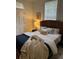 Cozy bedroom featuring a textured headboard, soft lighting, and a comfortable bed with decorative pillows at 84 Bull St # F, Charleston, SC 29401