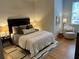 Relaxing bedroom features a cozy chair, natural light, and a well-designed layout at 84 Bull St # F, Charleston, SC 29401