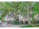 Beautiful home with a welcoming front porch, a fenced yard, and mature trees providing a picturesque setting at 84 Bull St # F, Charleston, SC 29401