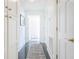 Bright hallway featuring white wainscoting, wood floors, and storage cabinets at 84 Bull St # F, Charleston, SC 29401