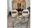 Cozy living room with designer chairs, area rug, and seamless dining room access at 84 Bull St # F, Charleston, SC 29401