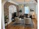Bright living room features exposed brick, hardwood floors, and plenty of natural light at 84 Bull St # F, Charleston, SC 29401