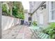 Inviting patio with blue chairs, a green bistro set, and a charming outdoor space perfect for relaxing and entertaining at 84 Bull St # F, Charleston, SC 29401