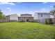 Lush backyard with green grass, a privacy fence, and mature trees, offering ample space for entertainment at 849 Kirby Ct, Charleston, SC 29414