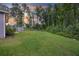 Large backyard with lush green grass surrounded by mature trees offering privacy at 849 Kirby Ct, Charleston, SC 29414