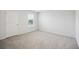 Empty bedroom with carpeted floor, a window with blinds, and a white painted door at 849 Kirby Ct, Charleston, SC 29414