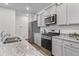Modern kitchen with gray cabinets, stainless steel appliances, and granite countertops at 849 Kirby Ct, Charleston, SC 29414