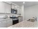 Modern kitchen featuring gray cabinets, granite countertops, and stainless steel appliances at 849 Kirby Ct, Charleston, SC 29414