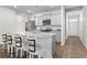 Bright open kitchen with gray cabinets, granite counters, a large island, and four chairs at 849 Kirby Ct, Charleston, SC 29414