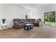 Cozy living room featuring a reclining sofa, sleek coffee table, and sliding glass doors to the backyard at 849 Kirby Ct, Charleston, SC 29414