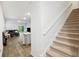 Open floor plan with wooden floors leading from stairs to living room with nice natural light at 849 Kirby Ct, Charleston, SC 29414