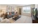 Cozy living room with natural light, neutral color palette, and comfortable seating at 849 Kirby Ct, Charleston, SC 29414