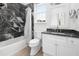 Updated bathroom features stylish shower tile, window with blind, and vanity with storage at 861 Center Park St, Charleston, SC 29492