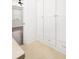 Hallway featuring neutral tiling with storage and view into bedroom with ceiling fan at 861 Center Park St, Charleston, SC 29492