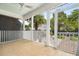 Screened porch with tile floor, fan, and view of backyard and lush trees at 861 Center Park St, Charleston, SC 29492