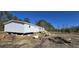 A newly constructed home with white siding, showcasing a wooden deck and landscaping in progress at 934 Tiger Loop, Saint Stephen, SC 29479