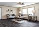 Cozy living room with stylish decor, wood-look floors, and plenty of natural light from large windows at 934 Tiger Loop, Saint Stephen, SC 29479