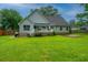 Spacious backyard featuring a well-maintained lawn and a charming house with a small porch at 1005 Trotters Blvd, Summerville, SC 29483