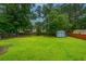 Large, green backyard with a shed and privacy fence offers ample space for recreation and gardening at 1005 Trotters Blvd, Summerville, SC 29483
