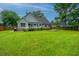 Expansive backyard featuring a well-maintained lawn and a charming house with a small porch at 1005 Trotters Blvd, Summerville, SC 29483