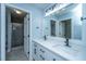 Bright bathroom with double sinks, modern fixtures, and tiled shower at 1005 Trotters Blvd, Summerville, SC 29483